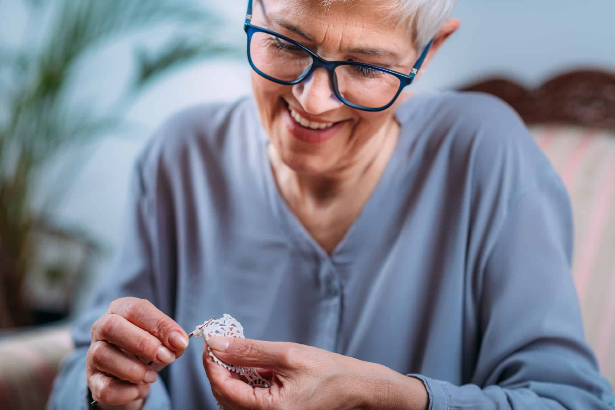 Crochet. Senior Woman Doing Crocheting at Home.