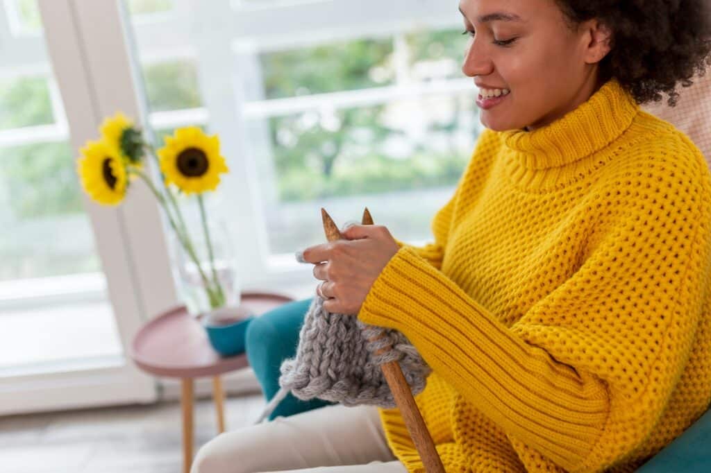Woman knitting at home
